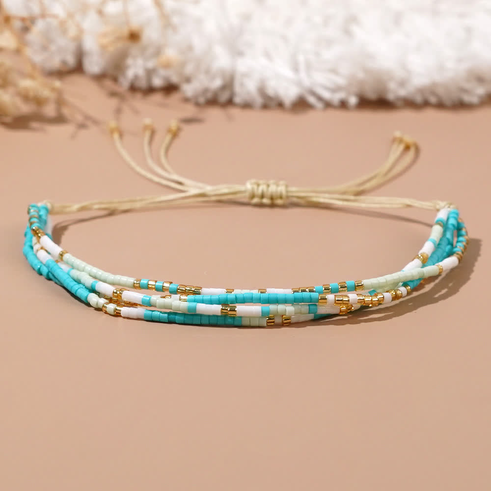 Olivenorma Armband aus Reisperlen, geflochten, für Strand und Surfen, Blau/Weiß