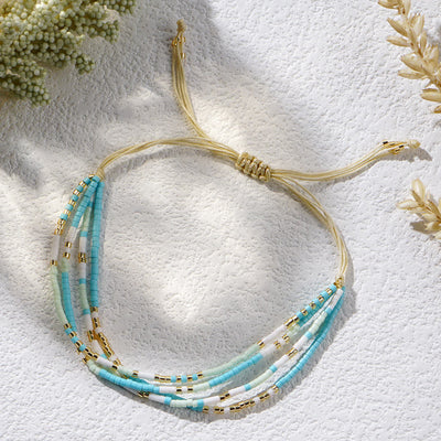 Olivenorma Armband aus Reisperlen, geflochten, für Strand und Surfen, Blau/Weiß