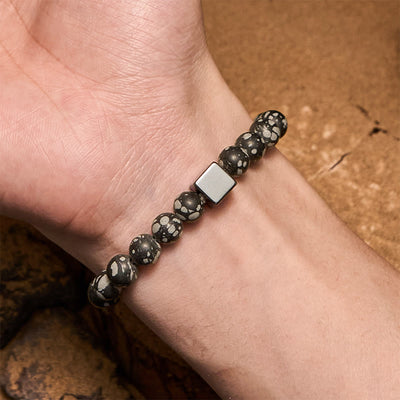 Olivenorma Schneeflocken-Obsidian-Armband mit Hämatit-Perlen im Quadratschliff