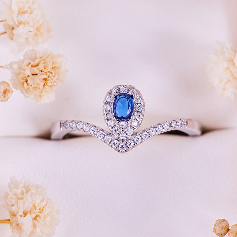 Olivenorma Tropfenkronen-Ring mit blauem Topas