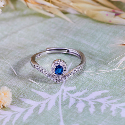 Olivenorma Tropfenkronen-Ring mit blauem Topas